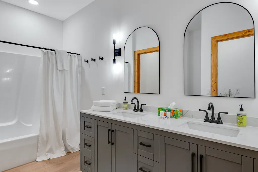 Spacious bathroom view with two mirrors and two sinks
