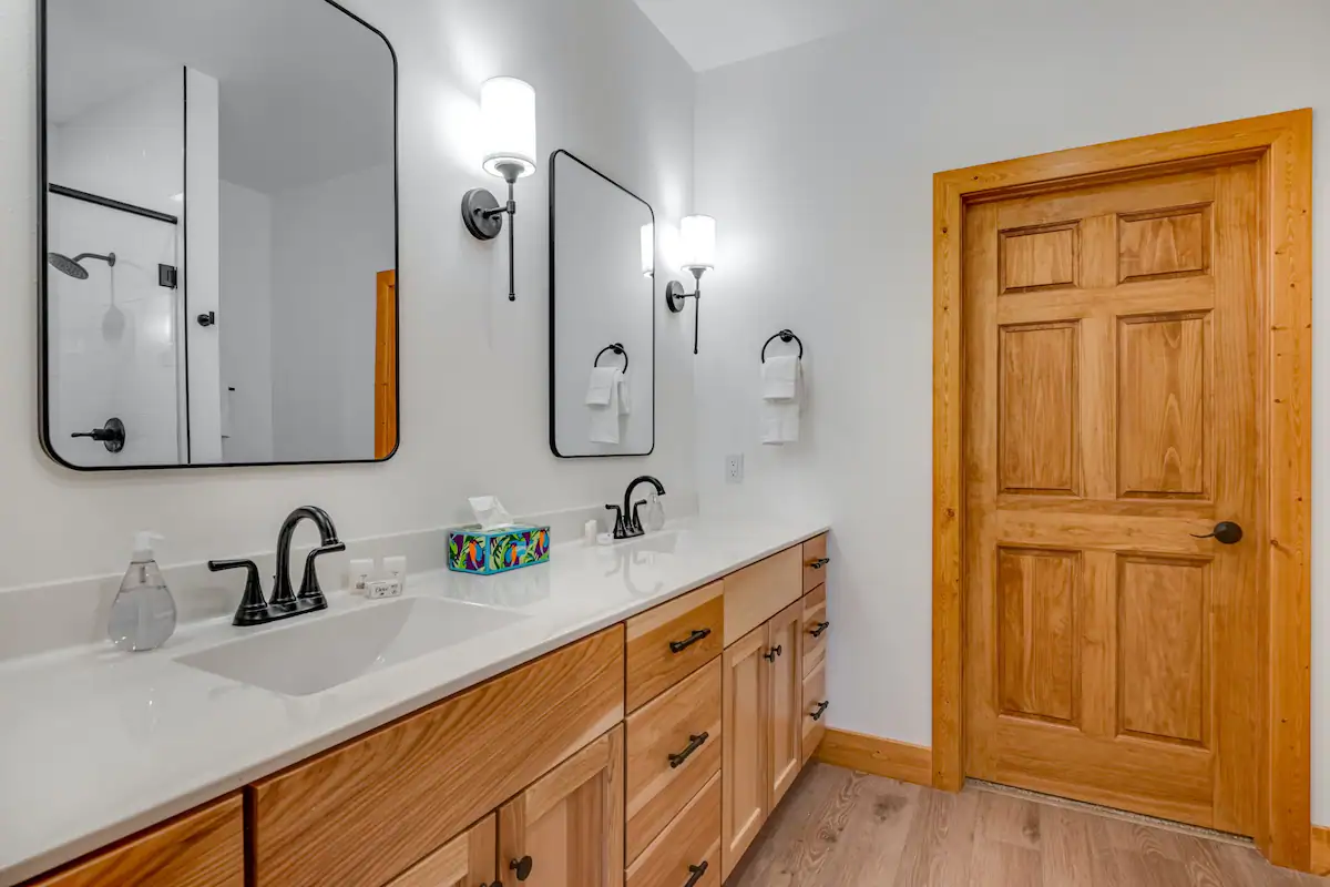 Photo of two side by side bathroom mirrors and sinks